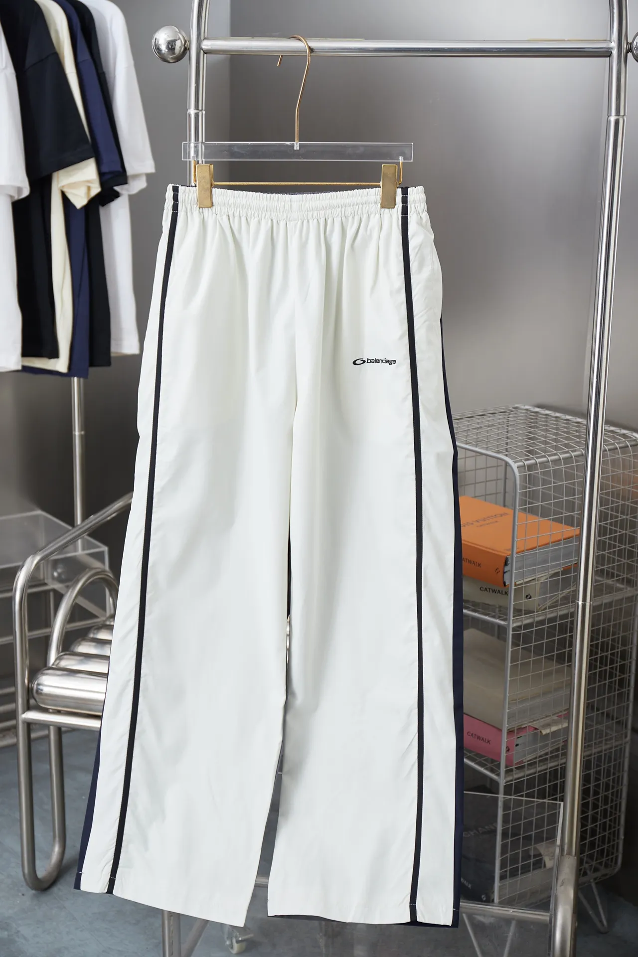 Balenciaga 𝘽𝘼𝙇𝙀𝙉𝘾𝙄𝘼𝙂𝘼 BLCG 25SS double-split waterproof sports pants. Light luxury. A must-have item for daily commuting for men and women. Correct version. Welcome to compare. Detailed features · Customized matt Taslan jacket fabric · The entire fabric is pre-treated with a waterproof coating · The interior is made of three-level polyester bird's eye mesh · OS ultra-loose silhouette design · Side pockets · Elastic waistband design · Contrast color Black webbing splicing · Front and rear contrast color splicing and cutting design · Imported Tajima machine embroidery ring logo · Original main mark washed tag brand packaging Color: White/Royal Blue Size: 46/48/50/52